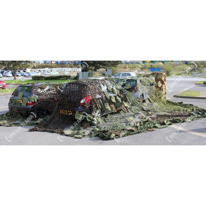 Rear view of Czech Army surplus camouflage net screening vehicles outdoors