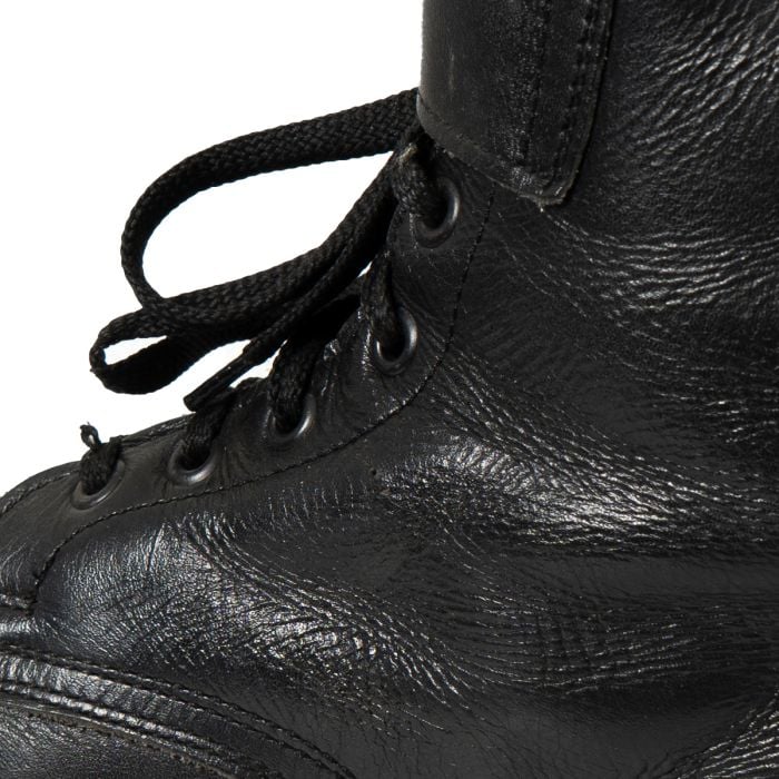 Close-up detail of the textured full-grain black cowhide leather on an Austrian combat boot.