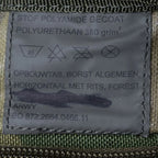 Inside military label of the Dutch chest pouch showing ARWY manufacturer name, polyurethane polyamide fabric details, and contract number