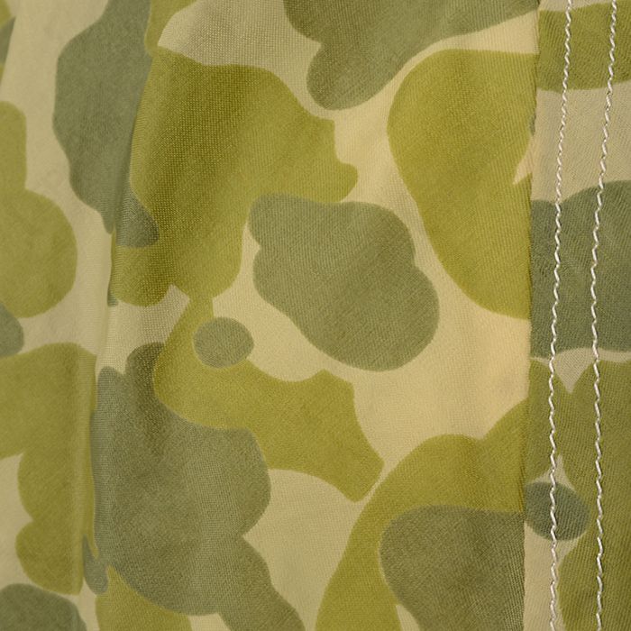 Detail view of frogskin green spot camouflage print and parachute seam stitching