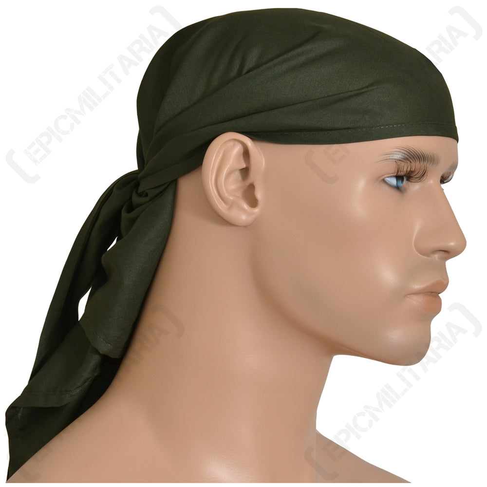 Side profile of a mannequin wearing an olive green Czech Army cotton bandana, showing the tied knot at the back of the head.