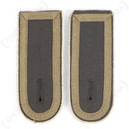 Front view of surplus German Bundeswehr Stabsunteroffizier shoulder boards with tan tresse on a dark grey wool base.
