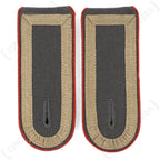 Close-up of German Bundeswehr Stabsunteroffizier shoulder boards with red branch piping and military rank insignia.