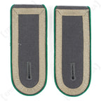 Pair of German Bundeswehr Stabsunteroffizier shoulder boards featuring green piping and standard military rank design.