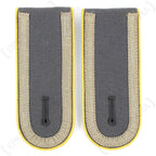 Pair of German Bundeswehr Unteroffizier shoulder boards with yellow piping and woven beige tresse on dark grey fabric.