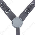 Close-up of East German Y-strap harness showing the central round vinyl back divider, reinforced stitching, and integrated metal D-rings on grey nylon webbing.