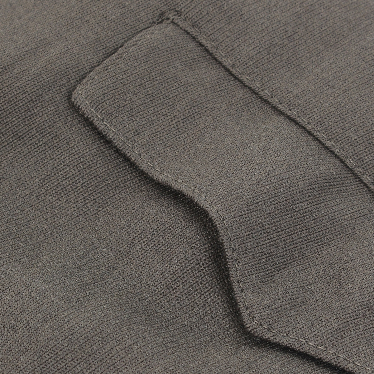 Macro detail shot of the durable wool-mix texture and sturdy stitching on a pocket flap of the authentic German Officer jodhpurs.