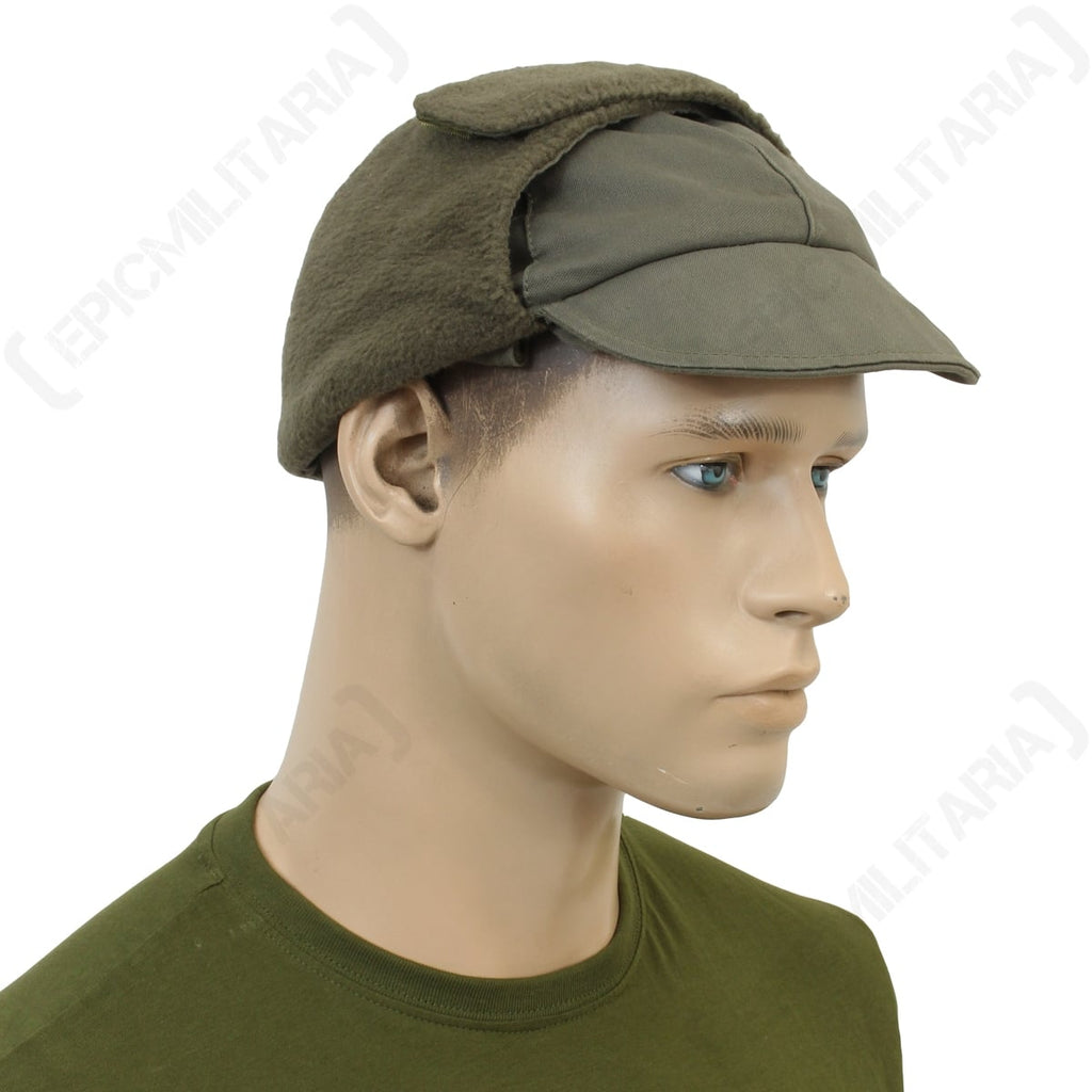 Side profile of the German Army winter cap showing the durable cotton construction and folded ear flaps.