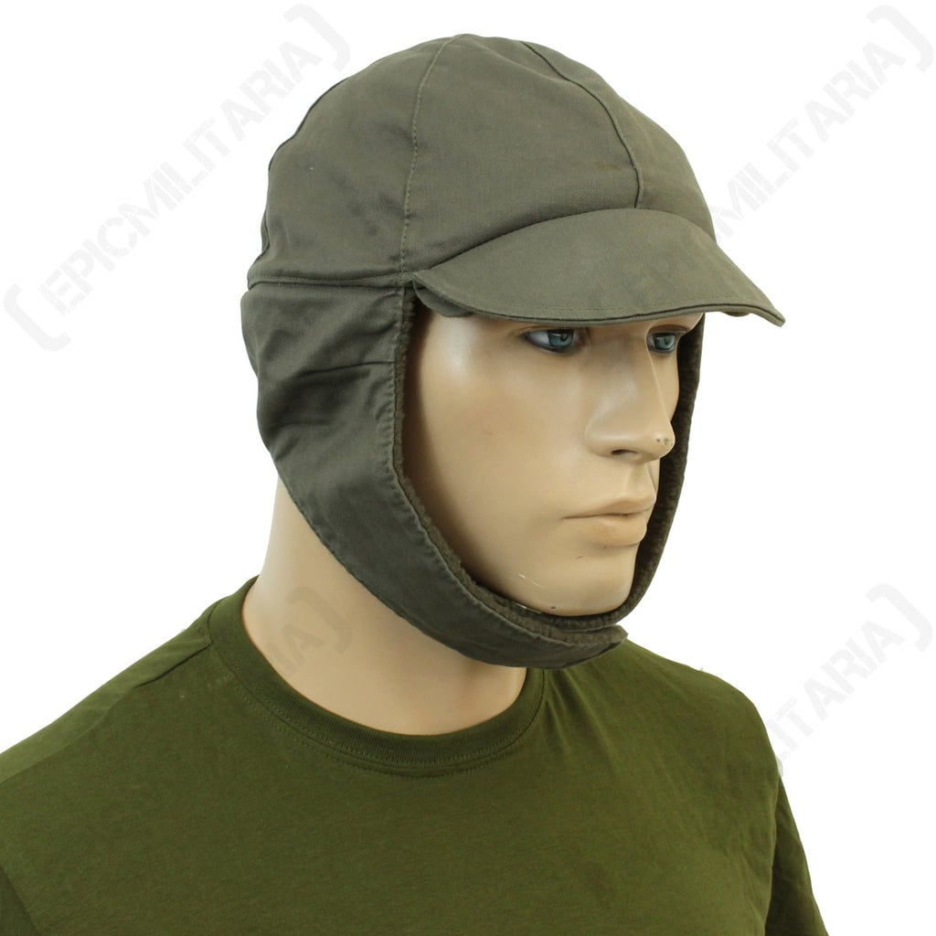 German Army winter cap with ear flaps extended downwards for full coverage, side profile view.