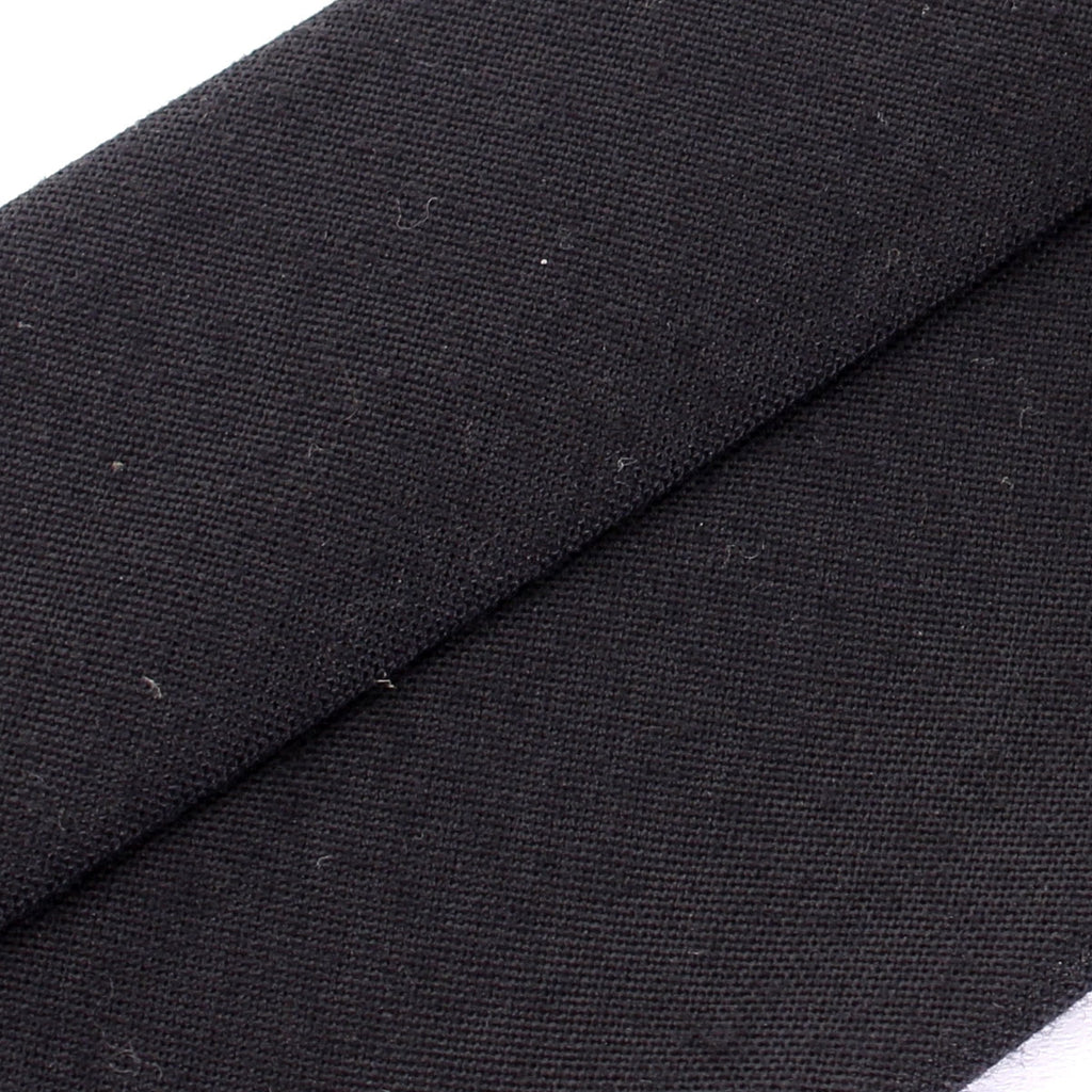 Macro view of the durable woven fabric on an authentic German Army necktie, highlighting the unique texture and signs of vintage wear.