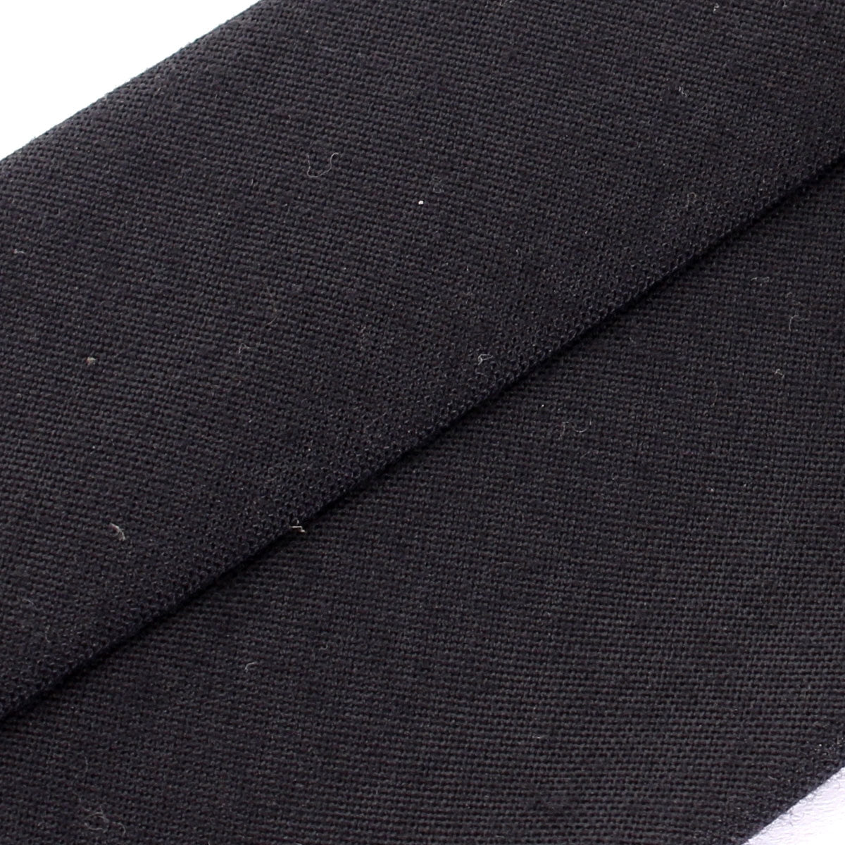 Macro view of the durable woven fabric on an authentic German Army necktie, highlighting the unique texture and signs of vintage wear.