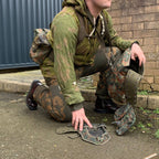 Person wearing a KZS camouflage sniper suit in a field setting, paired with tactical military gear.