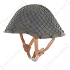 A side-profile view of a military helmet featuring an olive drab NVA camouflage net fitted securely over the shell.