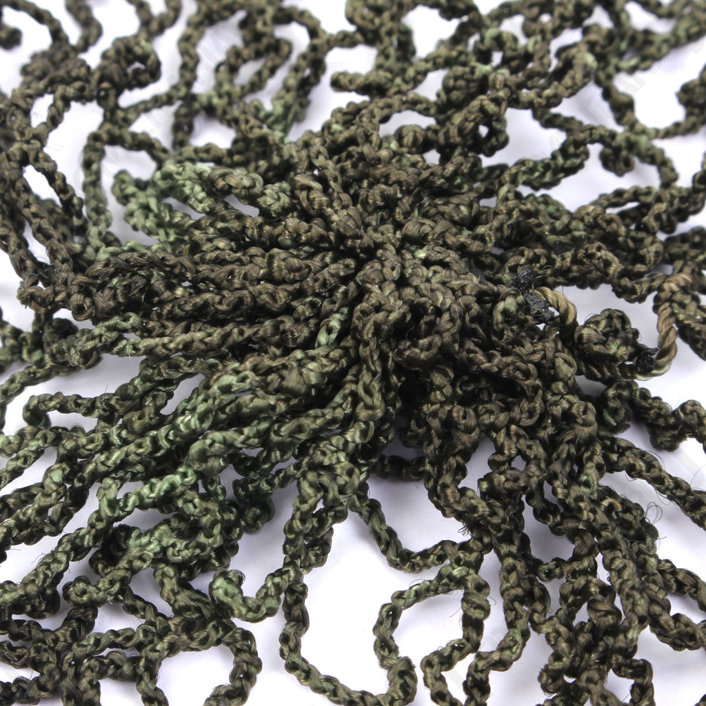 Close-up detail of the central knotted structure of the olive drab NVA helmet net showing the durable military-grade cord.