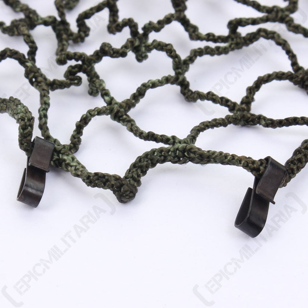 Macro shot showcasing the metal edge clips on the East German NVA helmet net designed for secure attachment to gear.