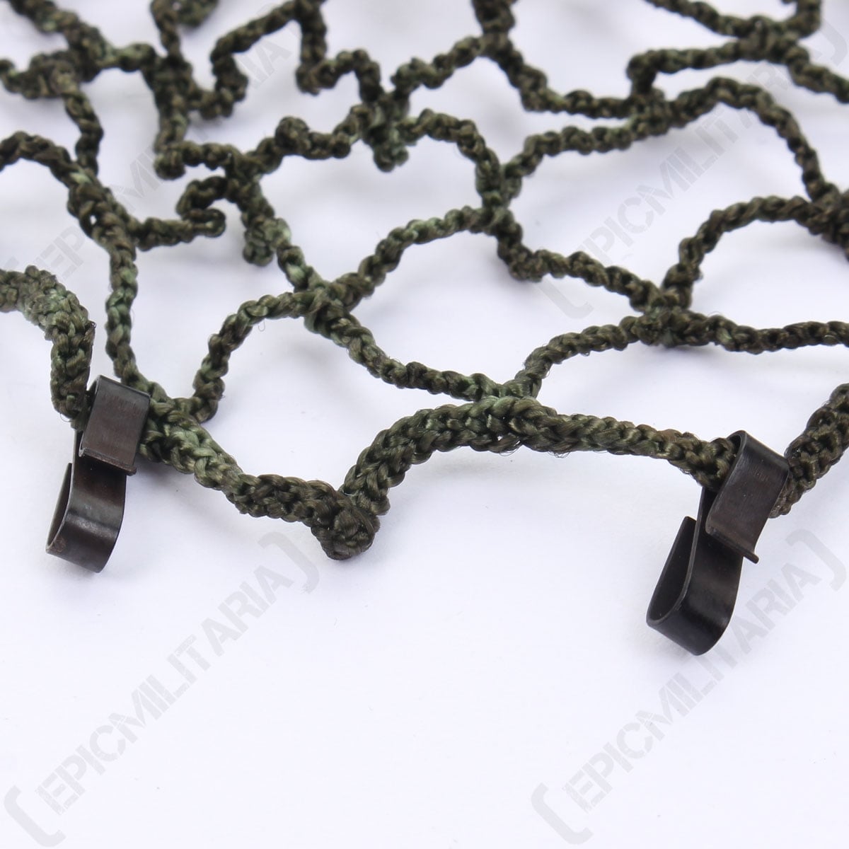 Macro shot showcasing the metal edge clips on the East German NVA helmet net designed for secure attachment to gear.