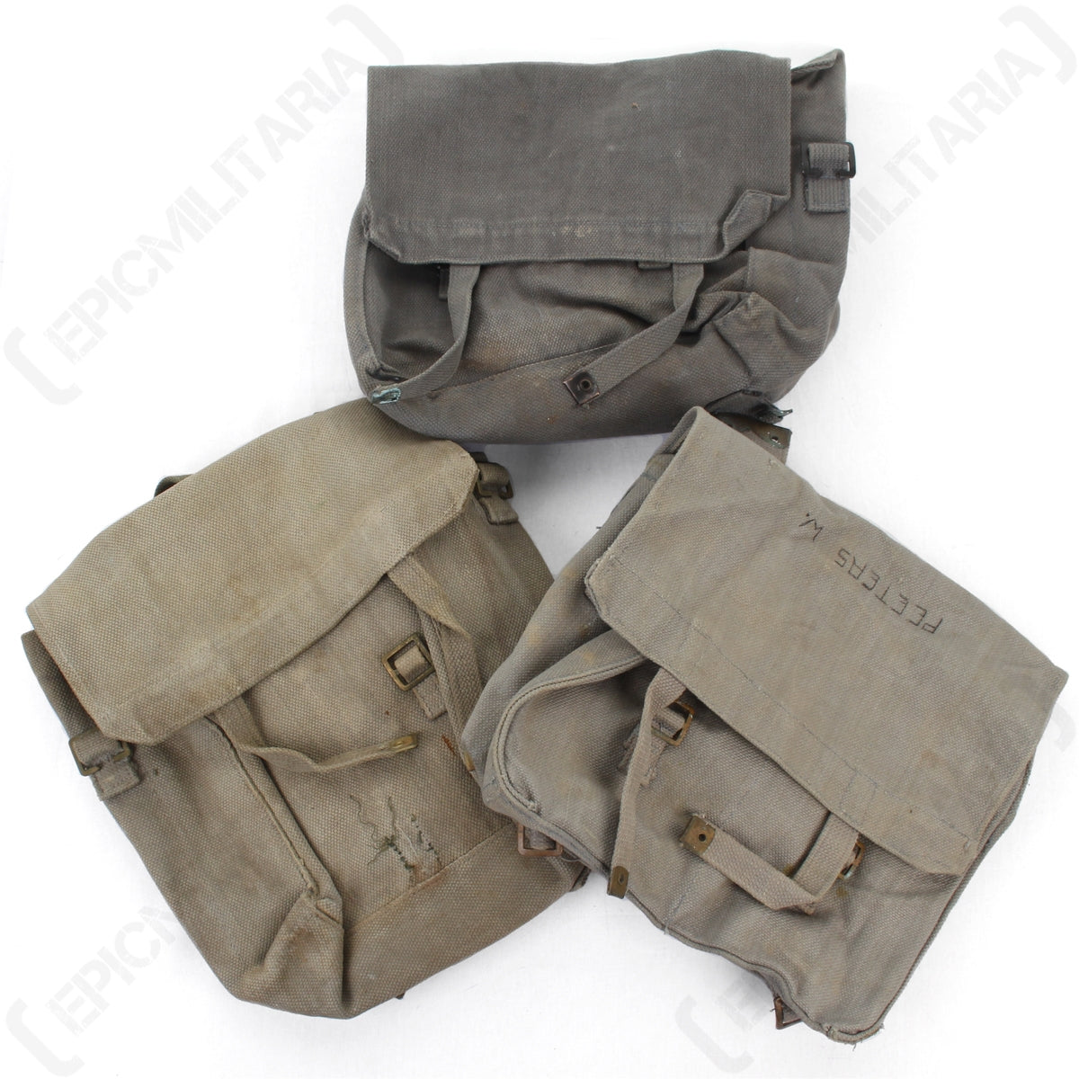 Collection of three authentic surplus 37 Pattern Small Packs showing variations in colour, texture, and historical service markings.