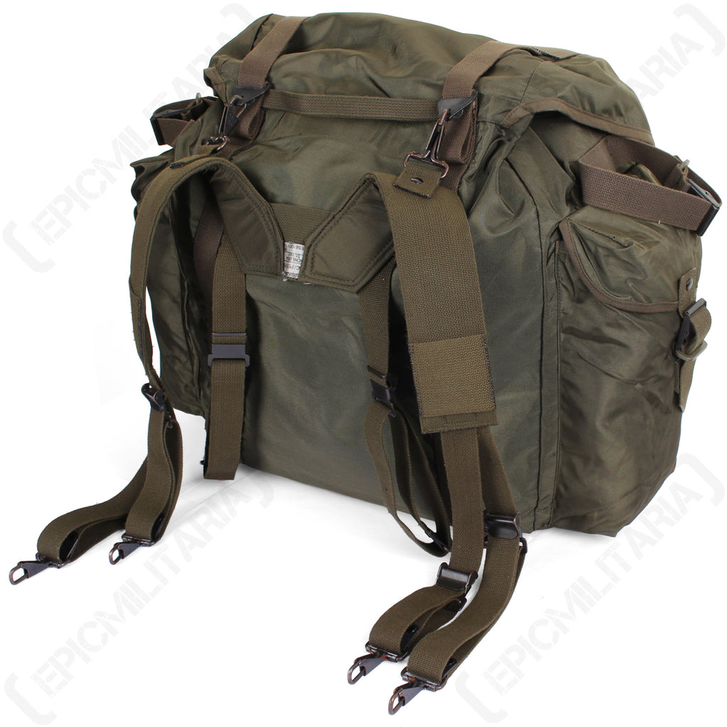 Angled rear perspective of the vintage Austrian olive drab rucksack, showcasing the military-grade strap attachment system.