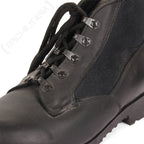 Close-up of a German Navy deck boot's lacing system, featuring black laces and reinforced metal eyelets with Stocko branding.