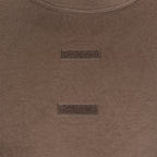 Detailed view of the hook and loop velcro strips on the chest of the brown German army tropical t-shirt.