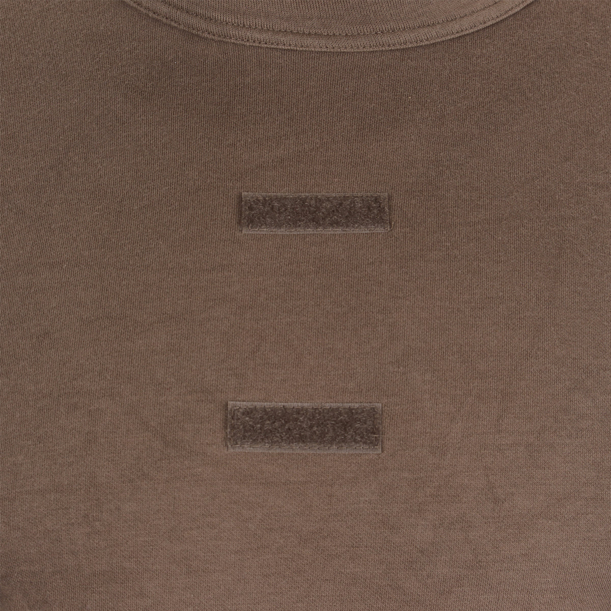 Detailed view of the hook and loop velcro strips on the chest of the brown German army tropical t-shirt.