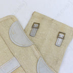 Close-up detail of Italian Army surplus gaiter showing durable canvas texture, grey leather reinforcements, and antique metal buckle hardware.