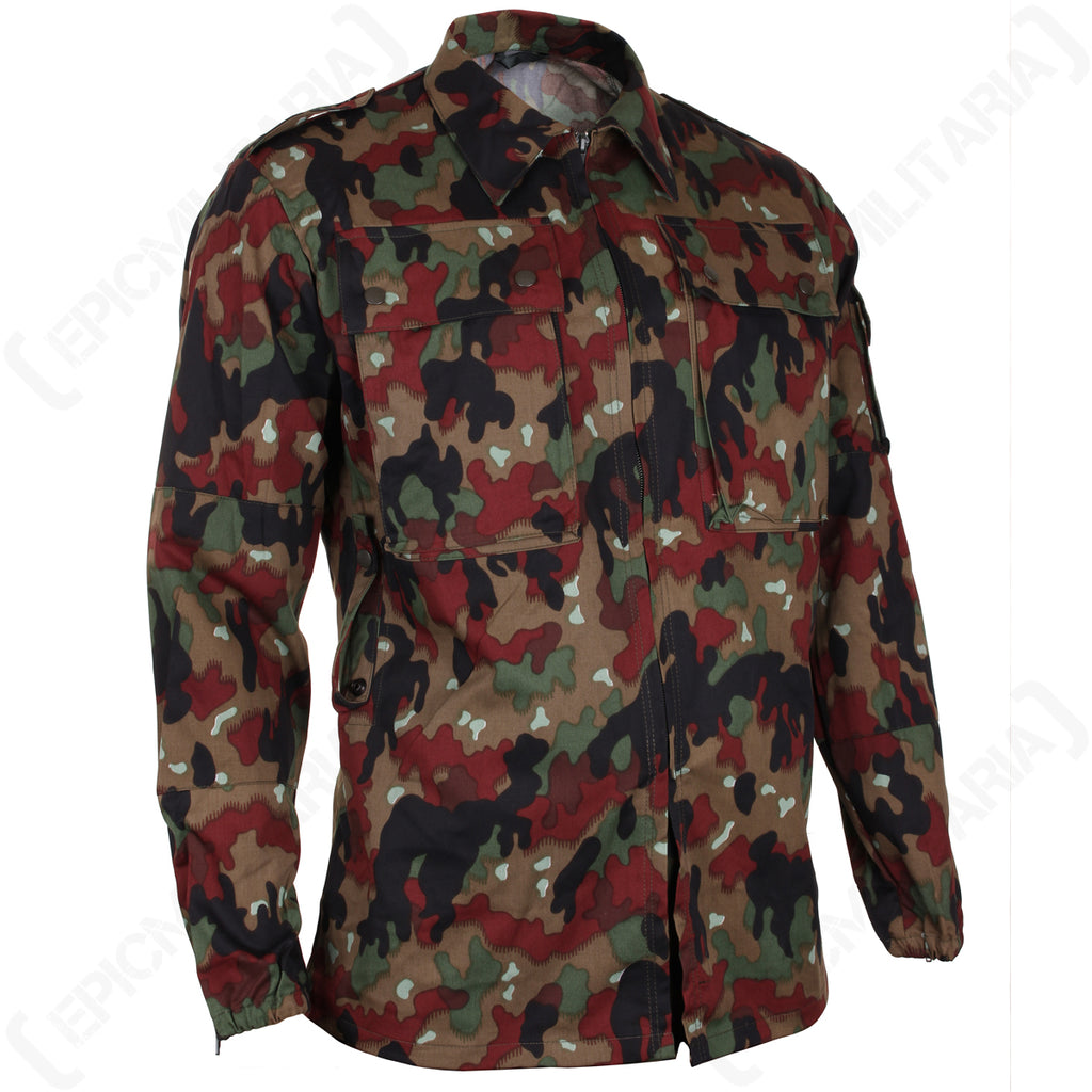 Three-quarter view of the Swiss M83 Alpenflage military jacket showing the robust cotton blend fabric, classic collar, and structured fit typical of authentic surplus gear.