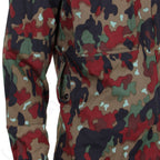 Close-up detail of the Swiss M83 field jacket showing the sturdy belt loop system and reinforced seams integrated into the genuine military surplus camouflage design.