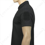Close-up side profile of the black polo sleeve showing the integrated hook-and-loop patch field.
