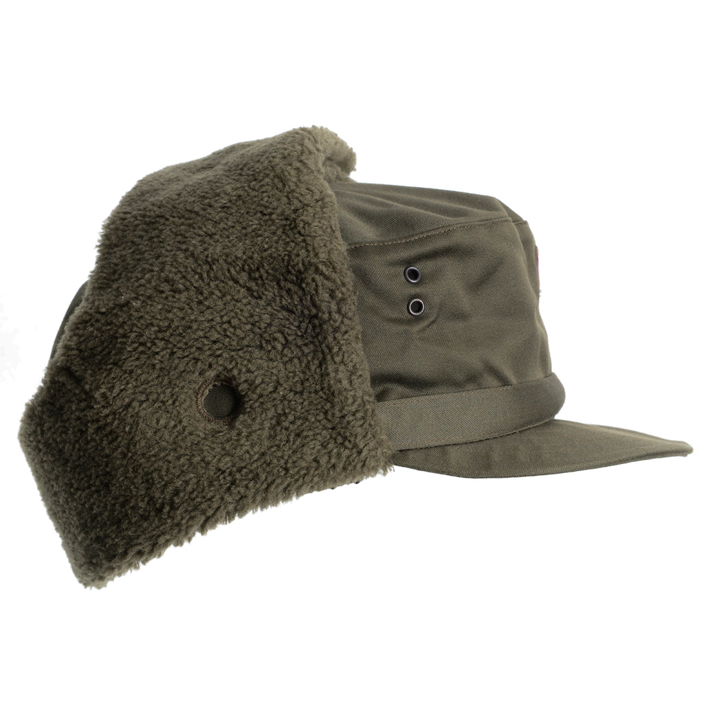 Side profile of the Austrian winter surplus hat featuring foldable ear flaps with metal snap buttons and side ventilation eyelets.