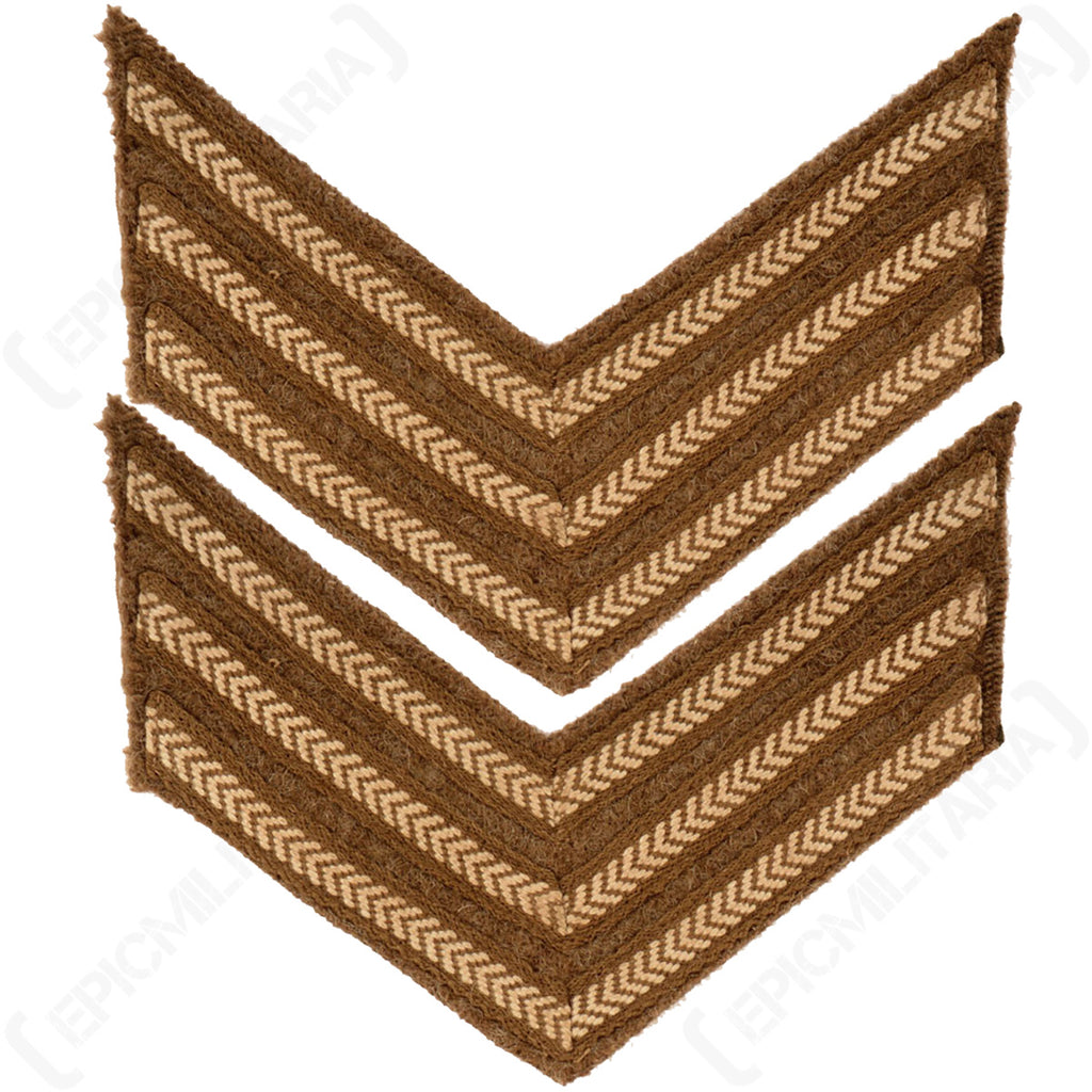 Pair of original WW2 British Army Sergeant rank chevrons featuring white cotton herringbone embroidery on a textured brown wool background for military re-enactment uniforms.