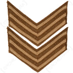 Pair of original WW2 British Army Sergeant rank chevrons featuring white cotton herringbone embroidery on a textured brown wool background for military re-enactment uniforms.