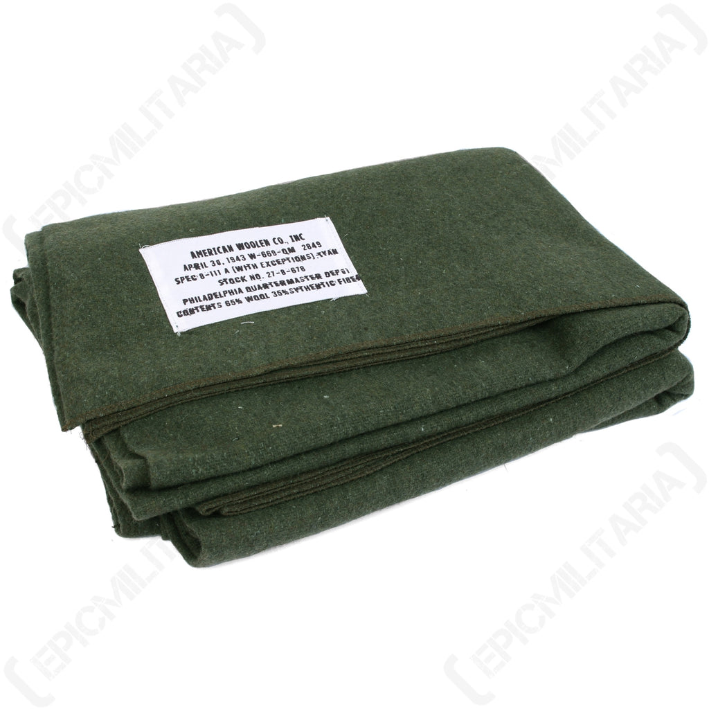 Folded WW2 US GI wool blanket with 1943 Philadelphia Quartermaster Depot reproduction label, olive green wool blend.