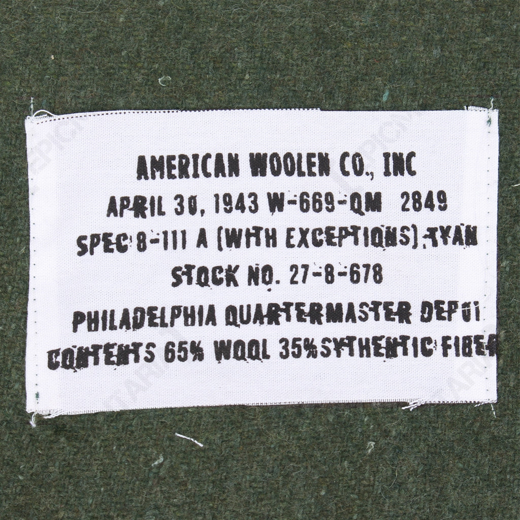 Close-up detail of the 1943 reproduction military blanket label, including Philadelphia Quartermaster Depot specifications and material composition.