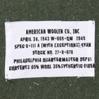 Close-up detail of the 1943 reproduction military blanket label, including Philadelphia Quartermaster Depot specifications and material composition.
