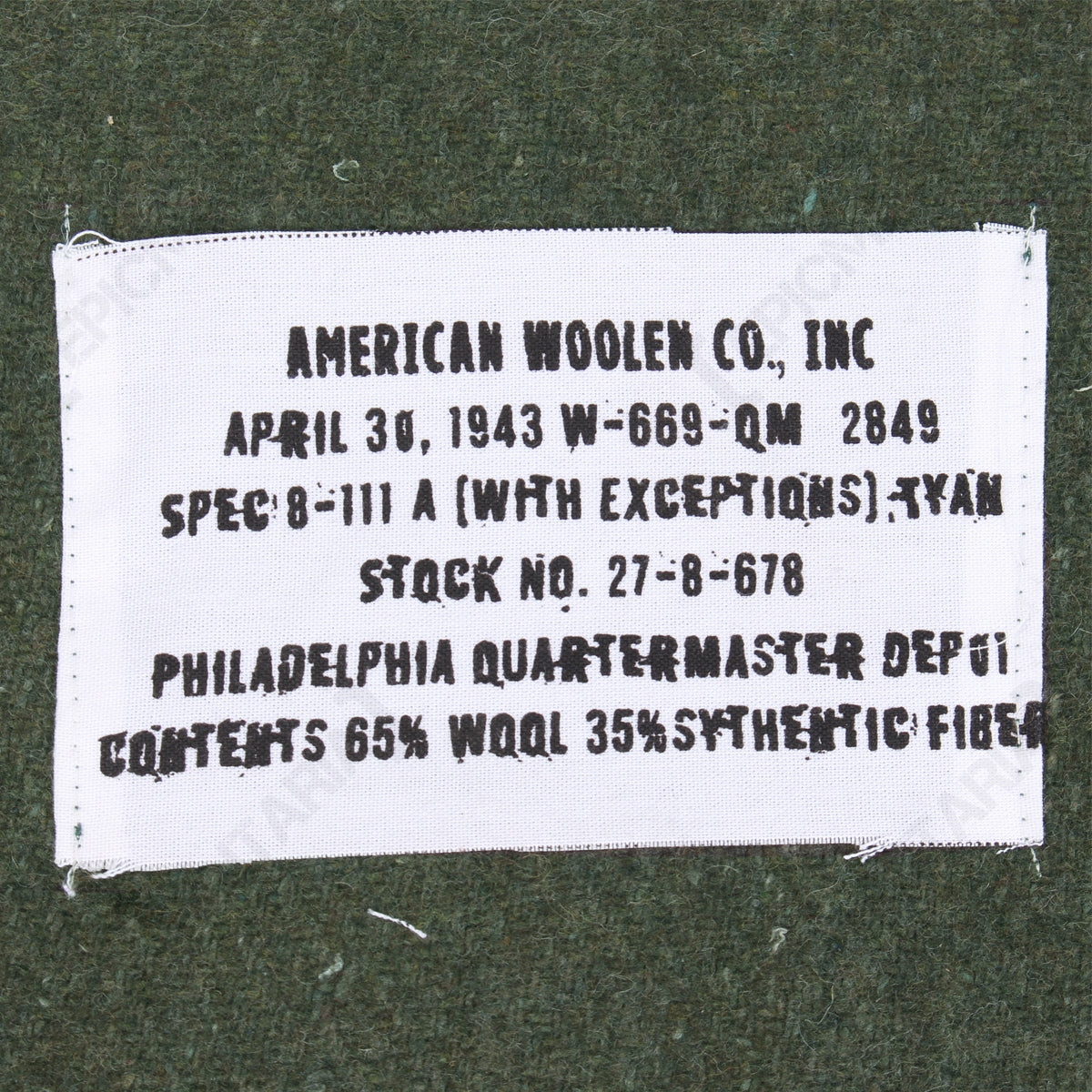Close-up detail of the 1943 reproduction military blanket label, including Philadelphia Quartermaster Depot specifications and material composition.