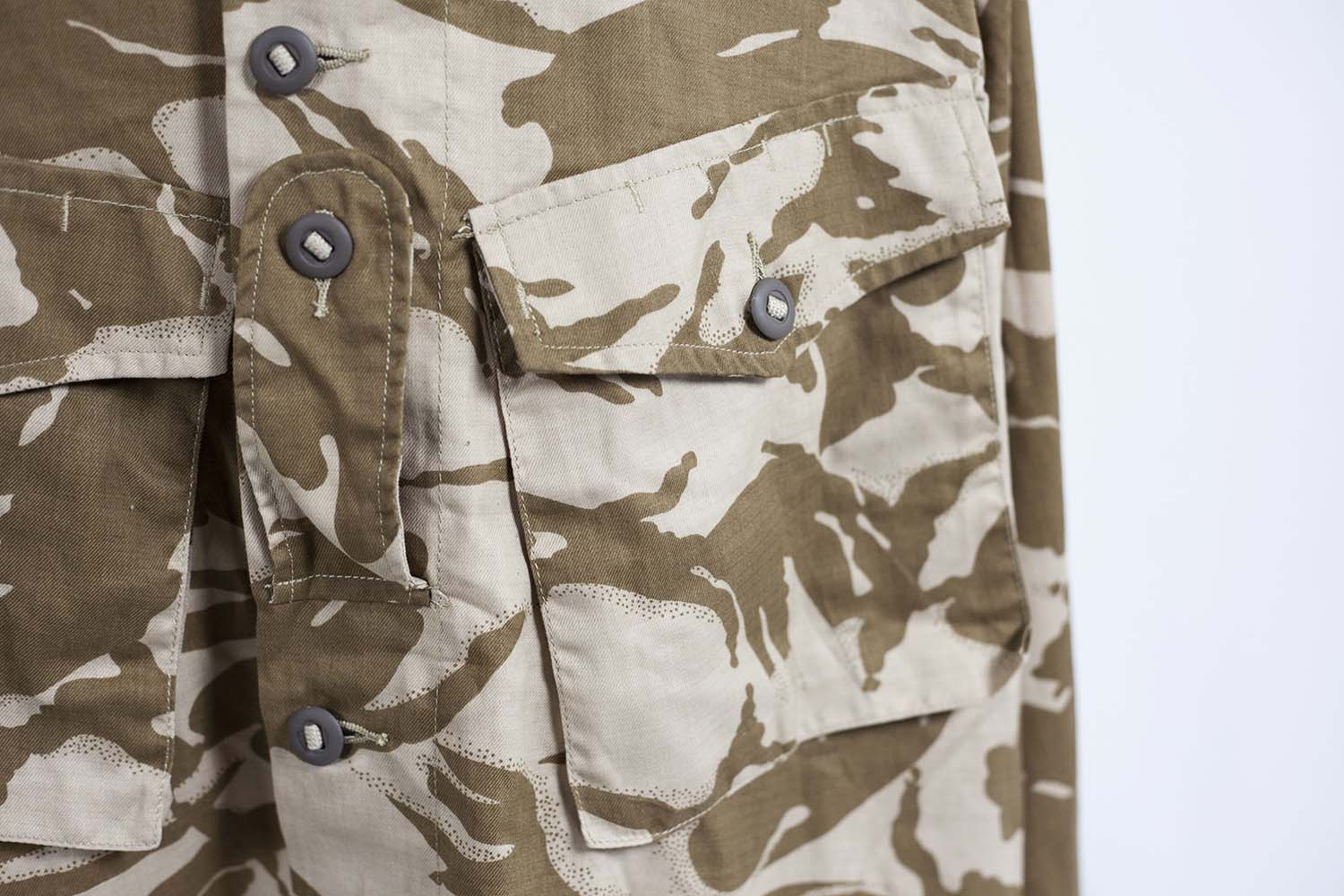 Detail view of the large angled chest pockets and heavy-duty fabric tape used for the Canadian-style buttons.