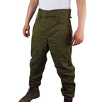 Model wearing Czech Cold Weather Combat Over-Trousers in olive green, featuring a high-waisted button design, side pockets, and durable cotton-polyester blend.