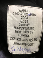 Close-up of the internal German garment label showing material composition including PES polyester, WO recycled wool, and CV viscose.