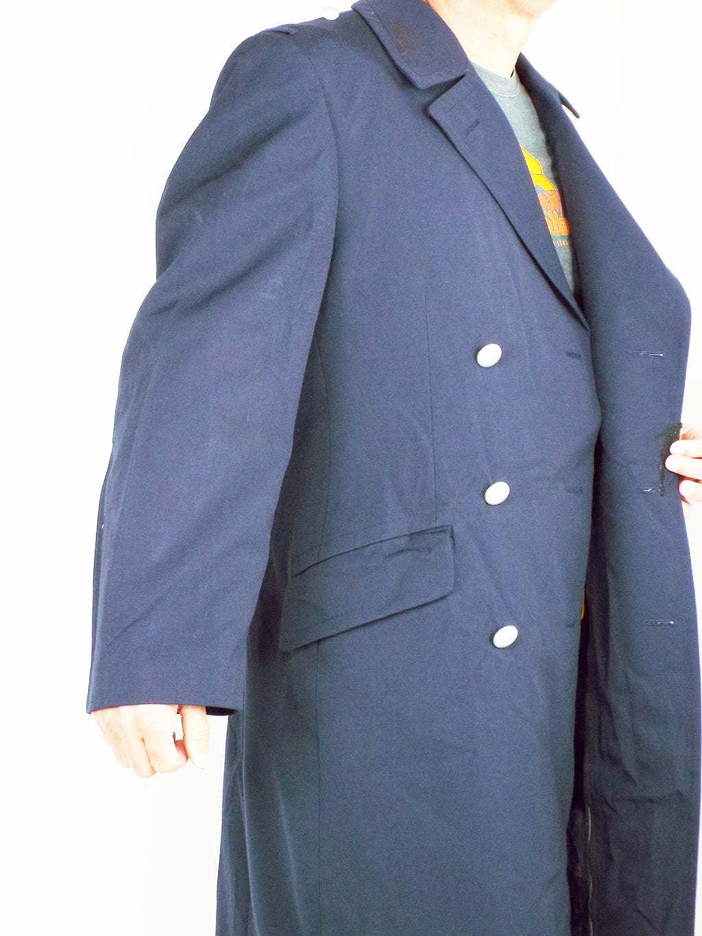 Side profile of the German Navy trench coat demonstrating the cut, silver button detailing, and deep flap pockets on the gabardine fabric.