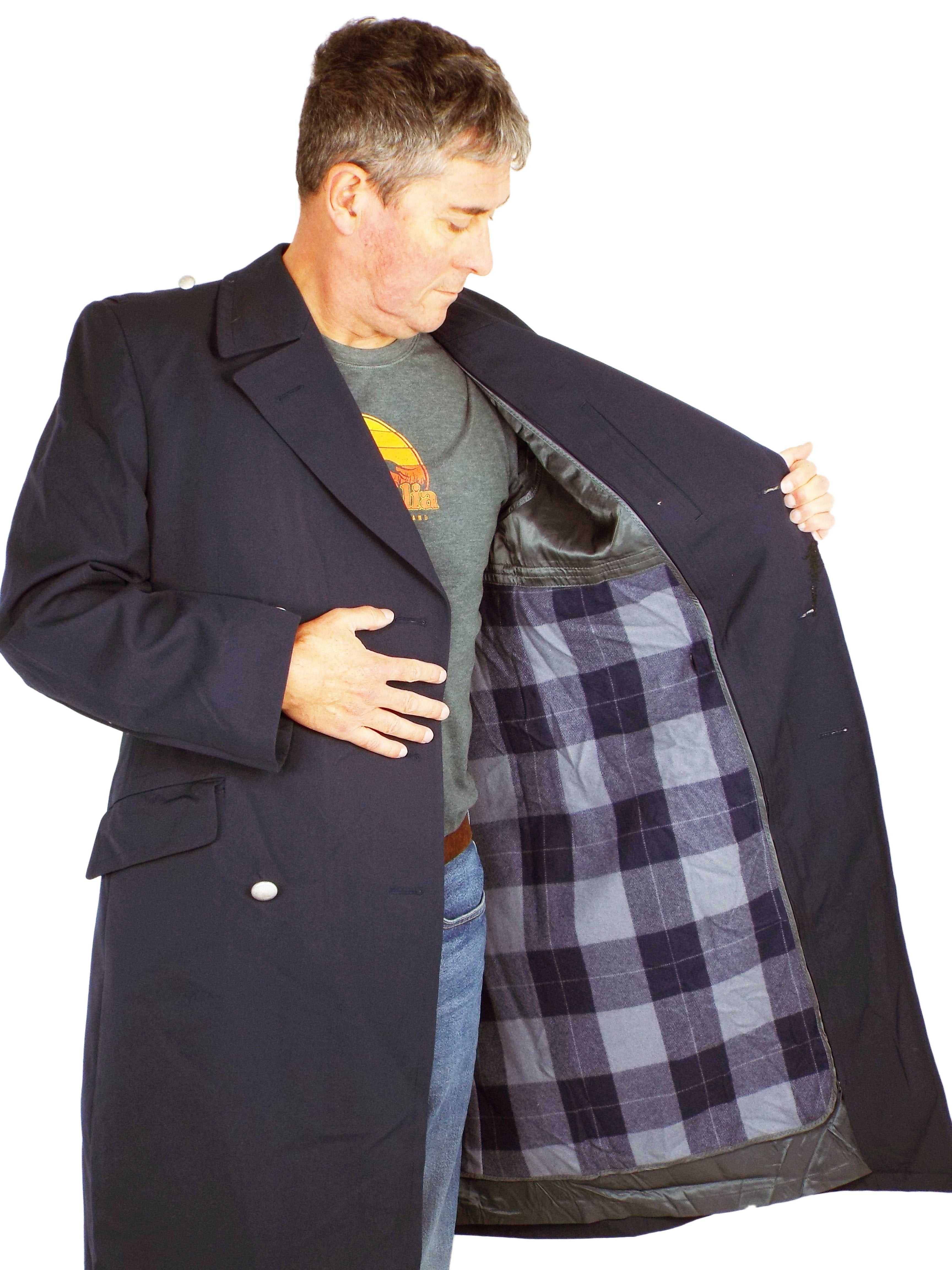 A model showing the interior of the German Navy trench coat, highlighting the removable grey plaid patterned liner inside the dark blue gabardine shell.