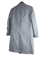 Rear view of the grey military trench coat, showing the classic back design, central vent, and durable gabardine fabric material.