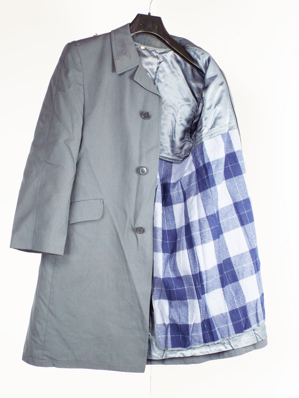 Genuine German military coat with a removable blue and white plaid inner lining, showcasing the versatile polyester construction.