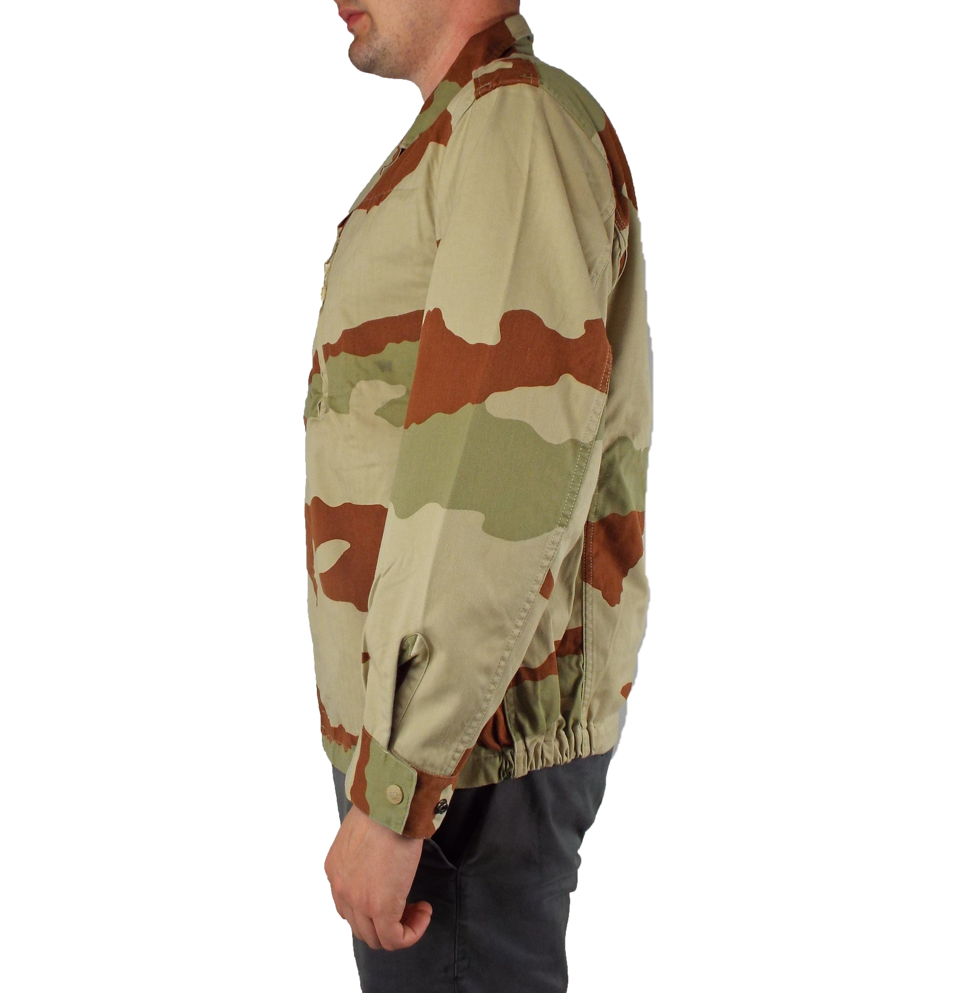 Side profile of the French Army CCE desert camo F2 jacket, showcasing the elasticated hem and adjustable buttoned wrist cuffs.