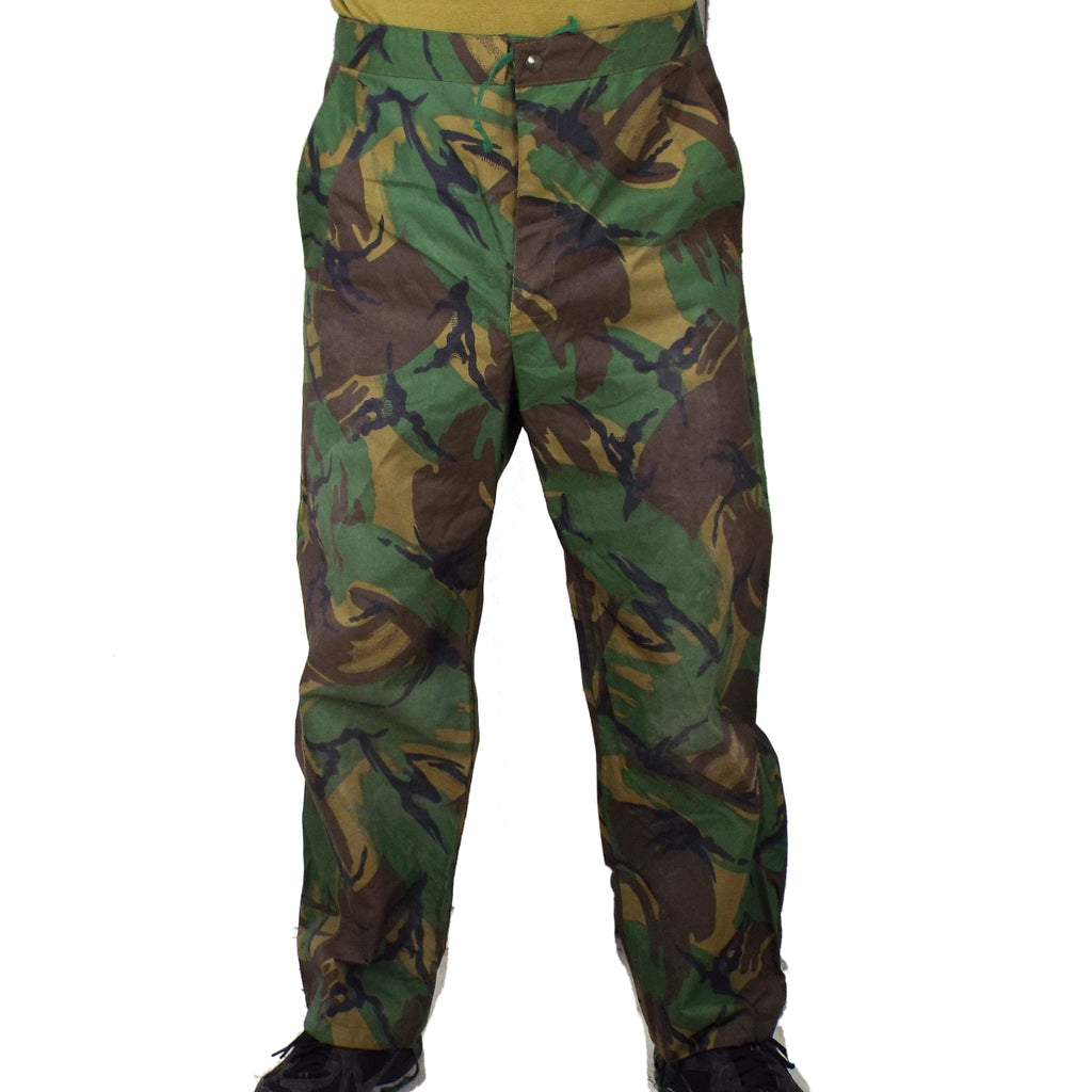 Front view of British Army DPM POL waterproof trousers featuring a drawstring waist and classic woodland camouflage pattern for outdoor use.