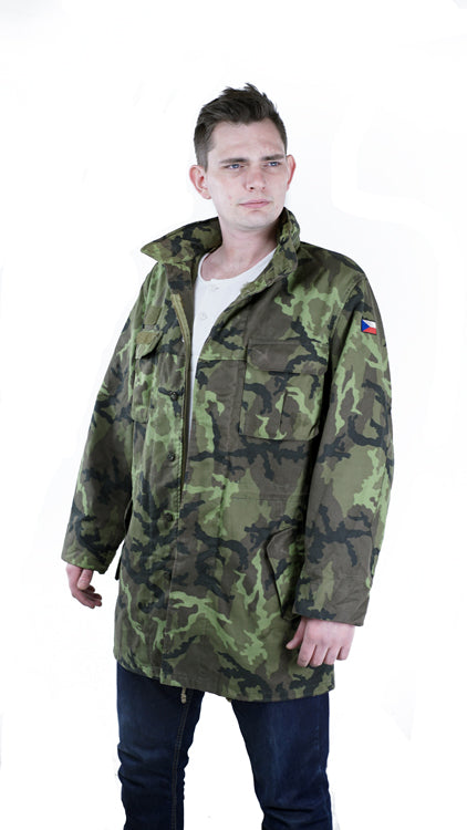 Full front view of a model wearing the Czech Army M95 camo parka with the coat fully unzipped and the hood tucked away.