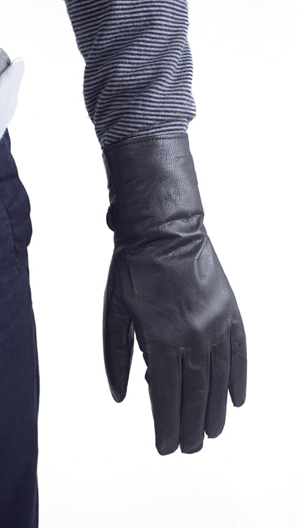 Close-up backhand view of genuine French military issue black leather glove featuring a smooth, durable finish.