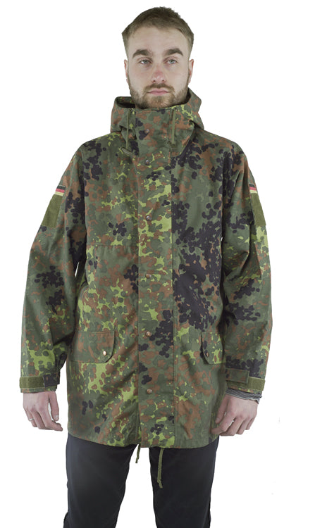 Front view of a genuine Bundeswehr military surplus Flecktarn parka with a large hood, zipper and press stud closure, and multiple storage pockets.