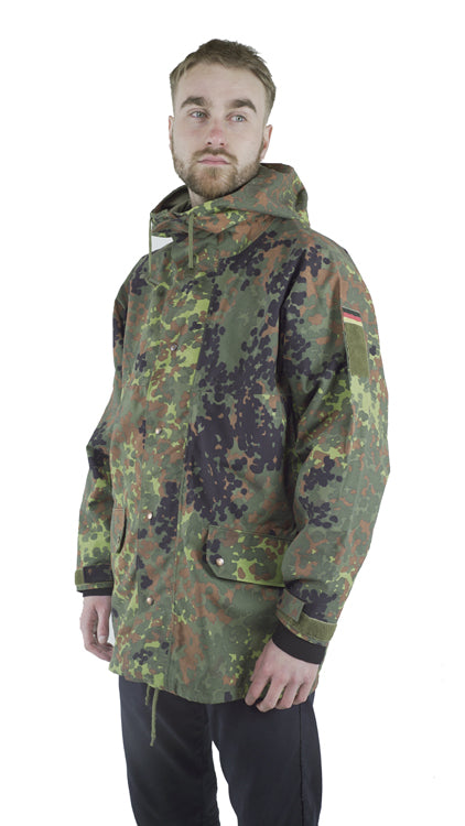 Side profile view of a German army Flecktarn parka featuring 5-color camouflage, German flag patch on the sleeve, and adjustable Velcro cuffs.