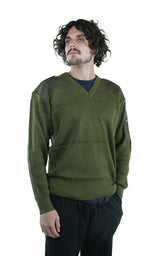 Side profile of a man modeling an unissued Italian military wool pullover, highlighting the olive green rib-knit texture and durable reinforced shoulder and elbow patches.